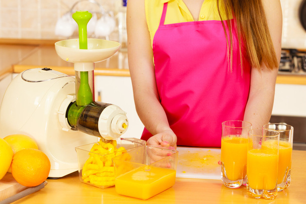 Woman pouring orange juice drink in glass - Photo, Image