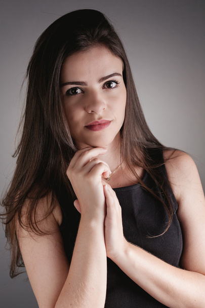 Portrait of beauty brunette girl over gray background - Photo, Image
