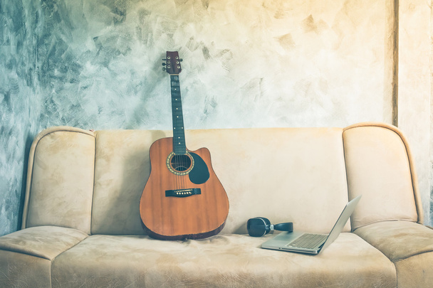Guitar with laptop and headphone on a sofa. Vintage tone. - Fotoğraf, Görsel