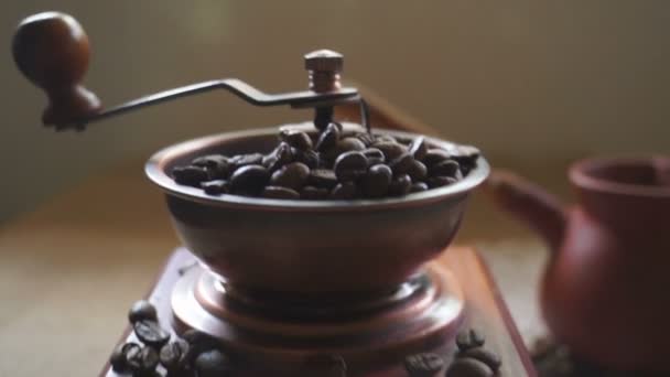 Coffee beans and an old coffee grinder. Moving the camera - Felvétel, videó