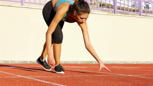 Track runner woman putting her hands at starting line - Footage, Video