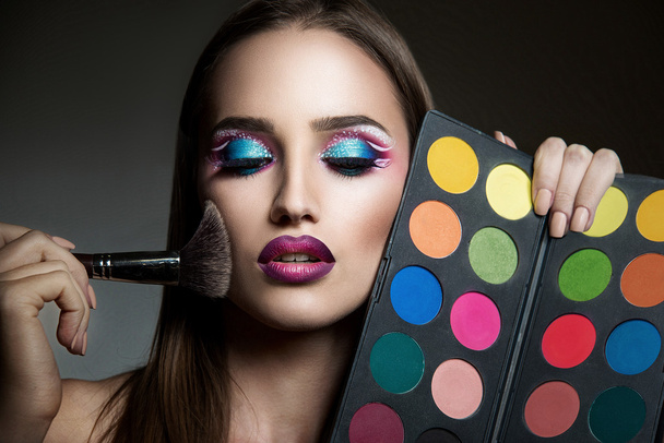 Portrait of beautiful sensual girl with color pallete - Photo, Image