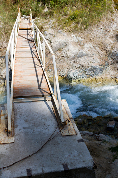narrow bridge across mountain river - Zdjęcie, obraz
