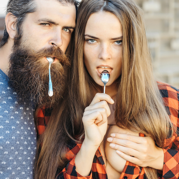 young couple with tea spoon - 写真・画像