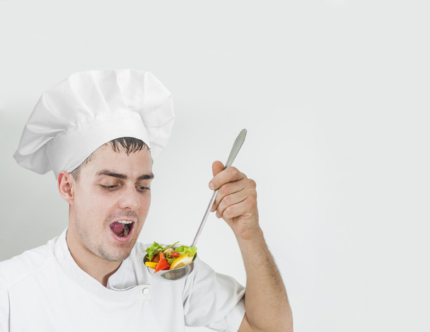 chef  in uniform eating out ladle full slices Vegetarian food - Fotó, kép