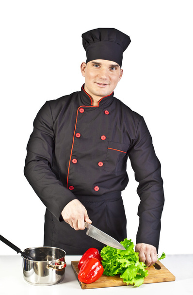 portrait of  cook cutting vegetables in salad in kitchen - Foto, Imagem