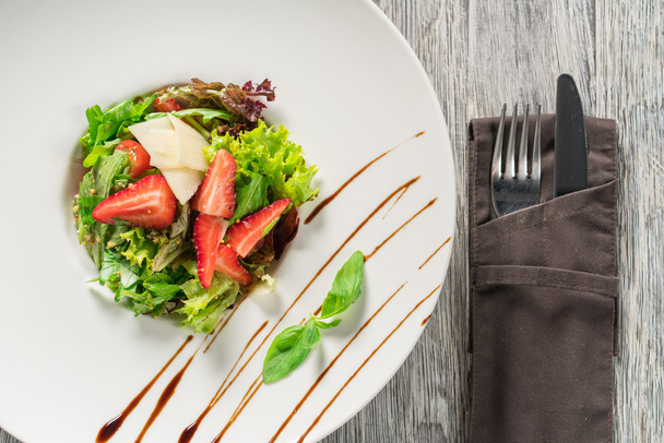 Salad greens, cheese and strawberries with balsamic sauce. - Fotó, kép