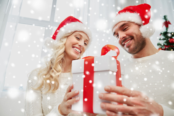happy couple at home with christmas gift box - Photo, Image