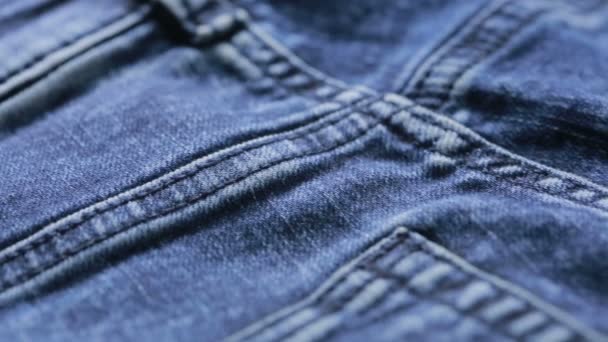 Blue jeans texture. can use as background. close-up of denim - Materiał filmowy, wideo