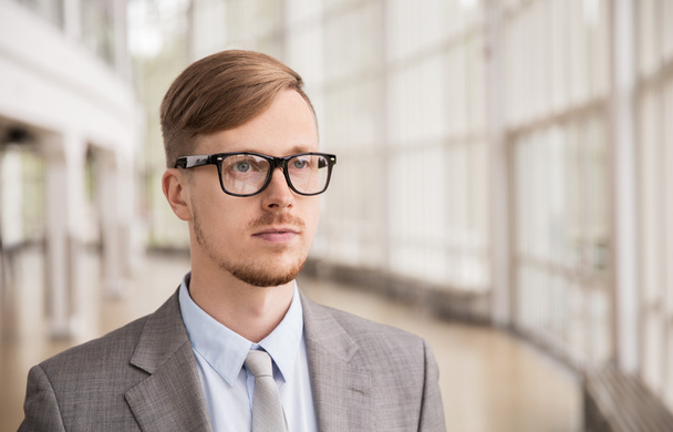 young businessman in suit and glasses at office - Фото, зображення