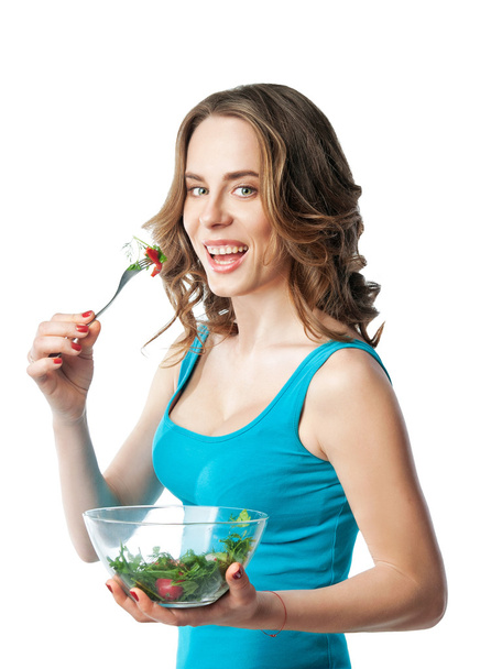 girl holding a plate and eating salad - Photo, Image