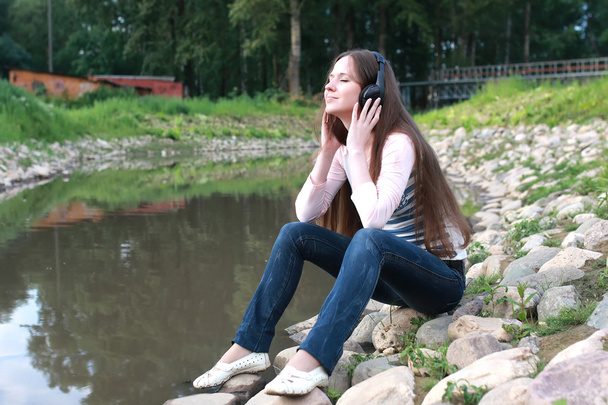 girl listen music in headphone outdoor - Photo, Image