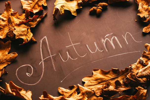 yellow leaves and the inscription autumn on a blackboard - Zdjęcie, obraz