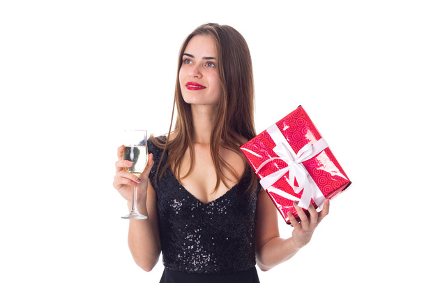 Young woman holding a present and a glass of champagne - Φωτογραφία, εικόνα