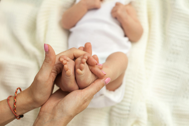 Hand holding little babys legs - Fotó, kép