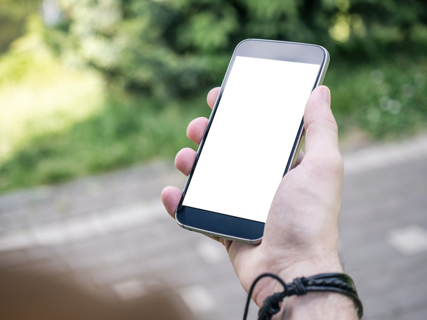 Modern SmartPhone in Man's hand with blank white screen - Foto, Bild