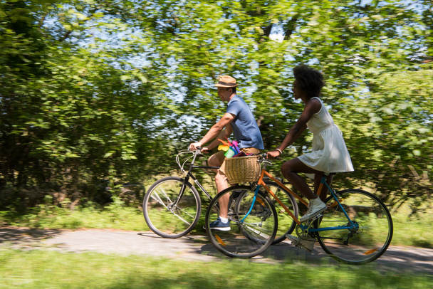 Young multiethnic couple having a bike ride in nature - Foto, Imagem