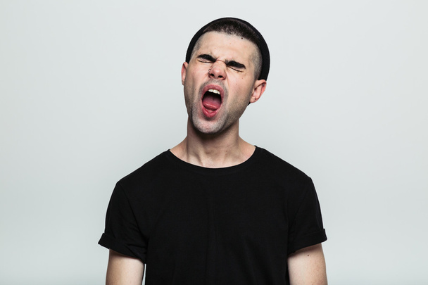 Portrait of man yawning. - Фото, изображение