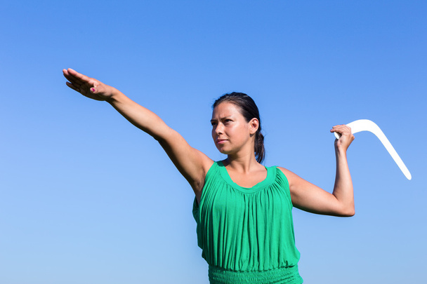Dutch woman throwing boomerang in blue sky - Photo, Image
