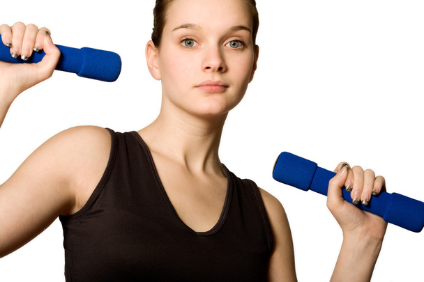 Young girl is holding the weights - Foto, Imagem