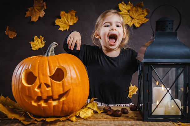 дівчина позує з гарбузом на Хелловін
 - Фото, зображення