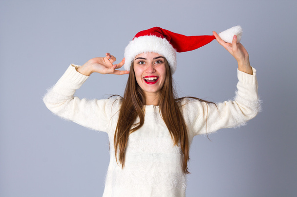 Woman in red christmas hat - Photo, Image