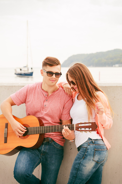 Happy couple with guitar outdoor - Фото, изображение
