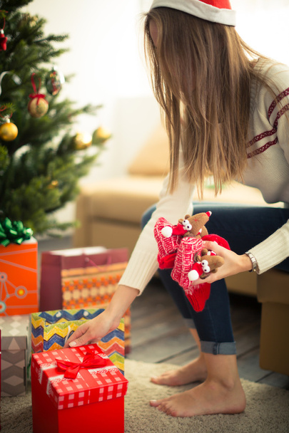 Mädchen wickelt das Weihnachtsgeschenk ein - Foto, Bild