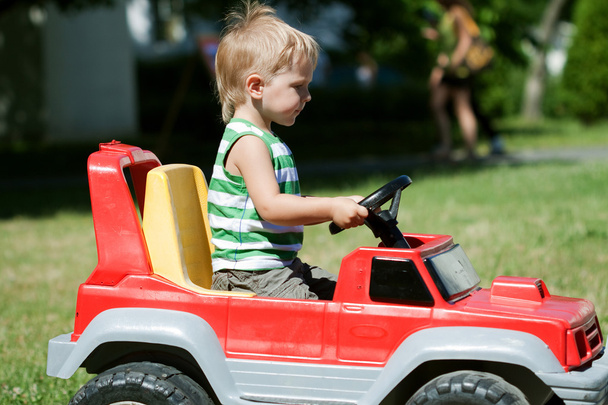 Boy in Toy Car - Foto, immagini