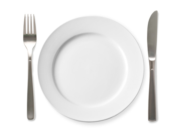 Empty plate with knife and fork on a white background.  - Zdjęcie, obraz