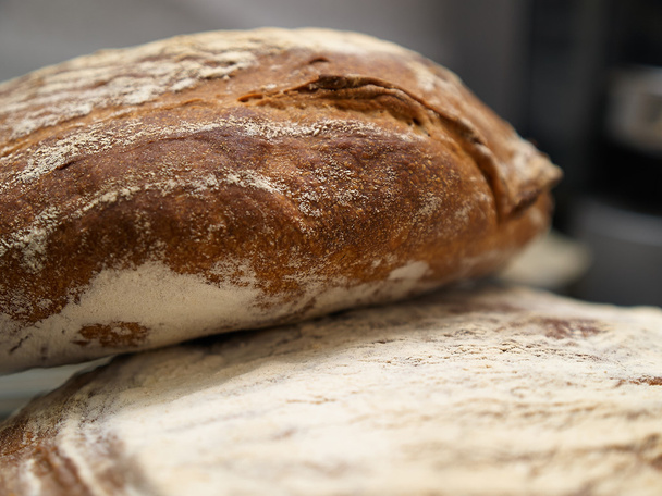 Freshly baked country rustic bread - Fotoğraf, Görsel