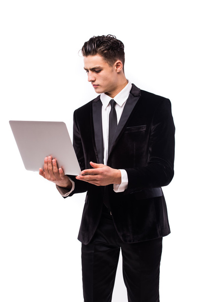 Portrait of smiling young businessman with laptop  - Фото, изображение