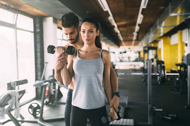 Personal trainer helping woman - 写真・画像