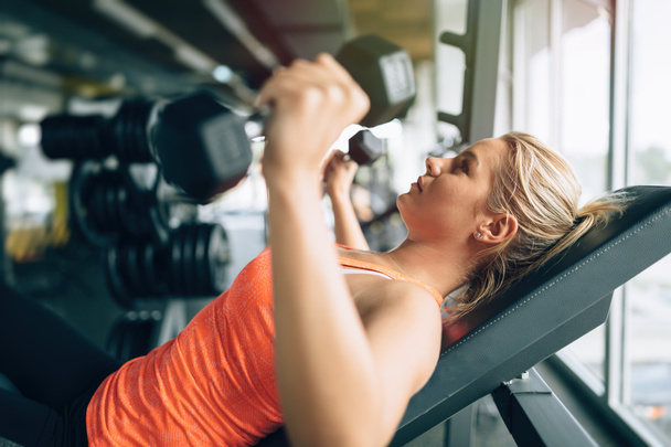 Woman practicing with dumbells - Photo, image