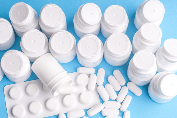 Many pills and tablets isolated on light blue background - Φωτογραφία, εικόνα