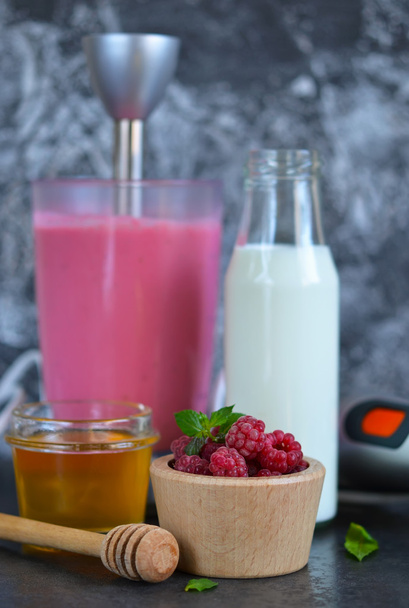 Berry smoothie for breakfast with honey and raspberry  - Fotó, kép