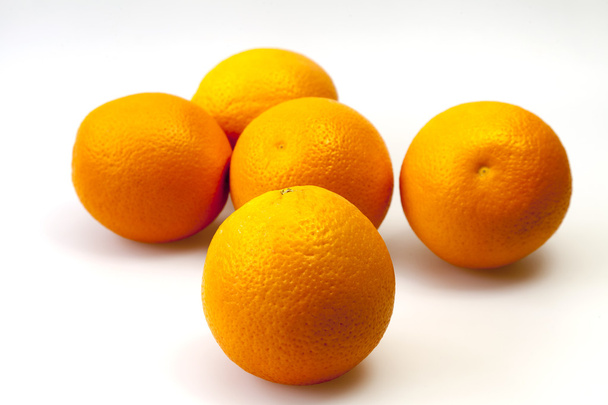 Bright juicy oranges on a table - Фото, изображение