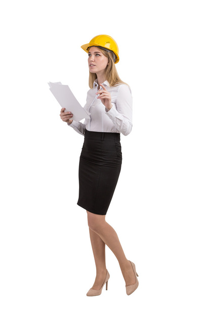 Woman with documents wearing hard hat - Foto, Bild