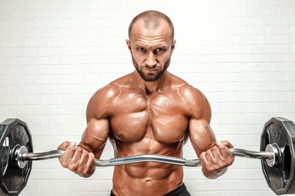 Strong man with weight bar - Foto, imagen