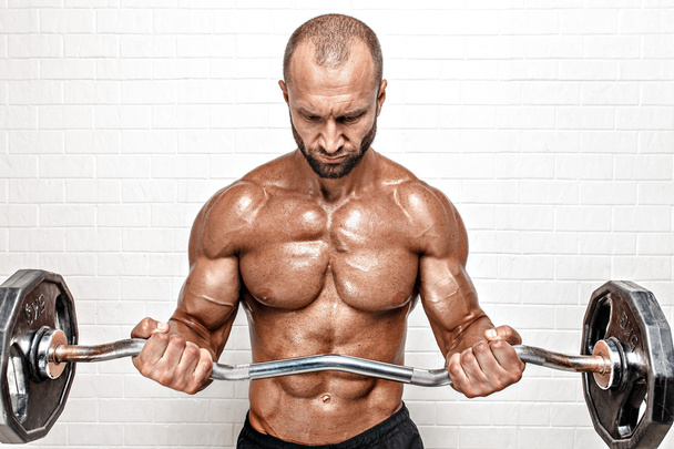 Strong man with weight bar - Foto, Bild
