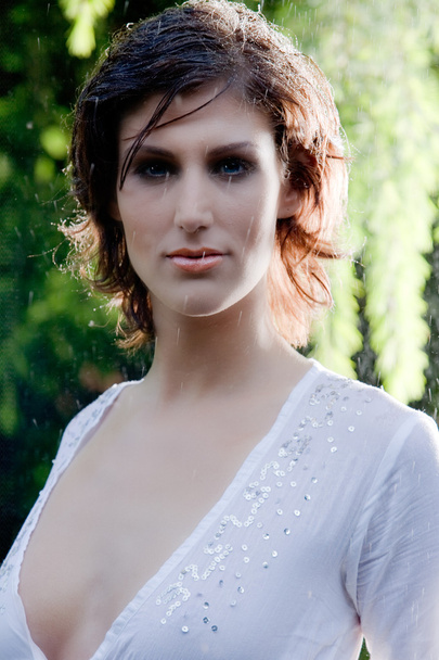 brunette in white blouse standing in the rain - Foto, Imagem