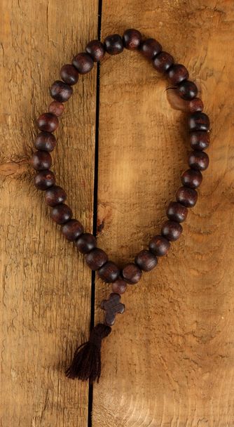 the Wooden rosary beads on wooden background close-up - Foto, immagini
