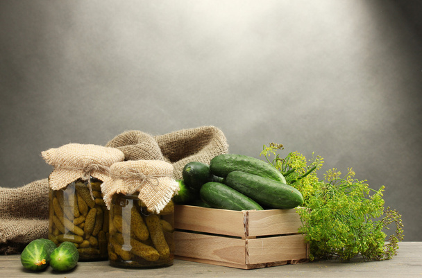 fresh cucumbers in wooden box, pickles and dill, on grey background - Photo, image