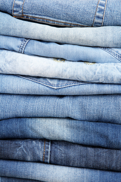 Many jeans stacked in a pile closeup - Foto, Imagem