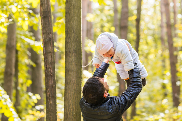 Father holds the little daughter in her arms, fatherhood, happy, family, walk - 写真・画像