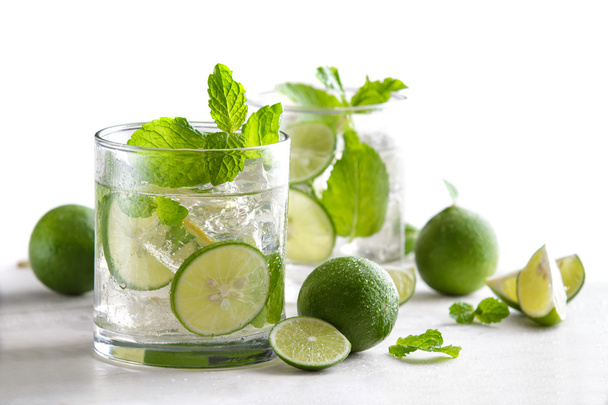 fresh mojito cocktail with fresh limes, mint, and ice - Zdjęcie, obraz