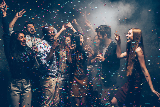 people dancing at party with confetti - Foto, Bild