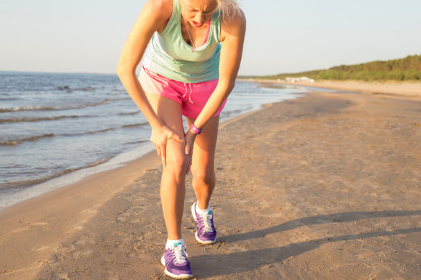 Mujer fitness con dolor en la rodilla
 - Foto, imagen