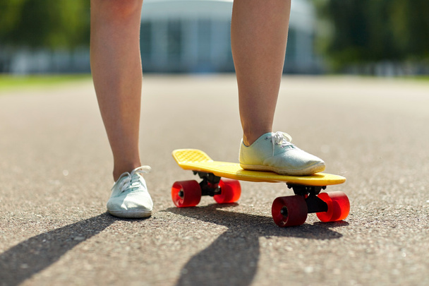 close up of female feet riding short skateboard - Foto, Imagen