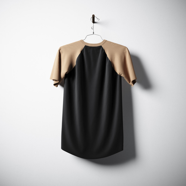 Blank cotton tshirt of brown and black colors hanging in center empty concrete wall. Clear label mockup with highly detailed texture materials. Square. Back side view. 3D rendering. - Foto, Bild